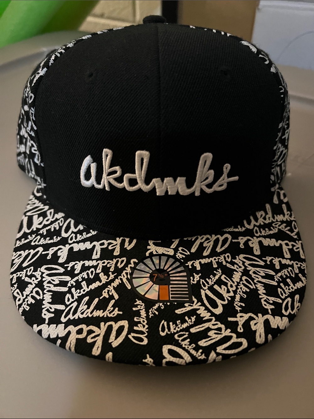 Akademiks Black and White cap 7 3/8 with Red Logo Tag
